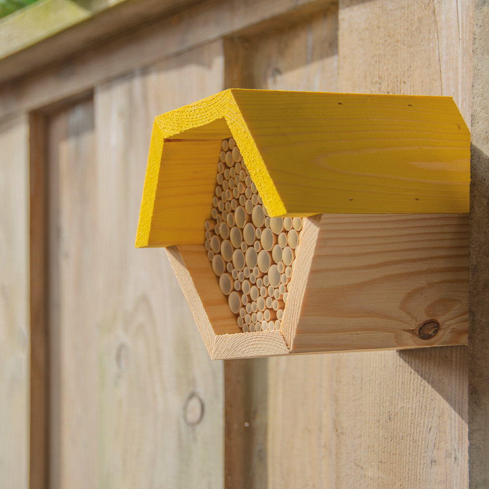 Wildbienen-Nisthilfe mit Pappröhrchen an Hauswand