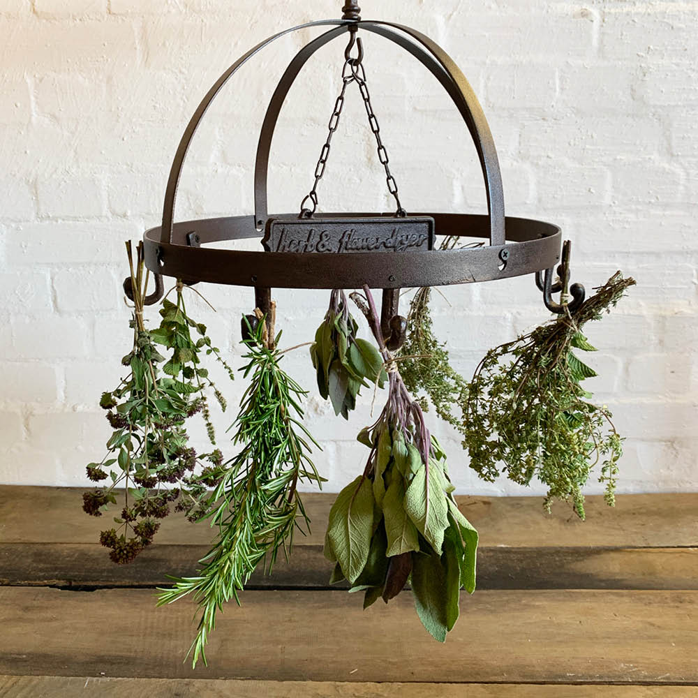 Rustikaler Kräuterhänger aus Gusseisen im Landhausstil mit getrockneten Kräutern am Haken